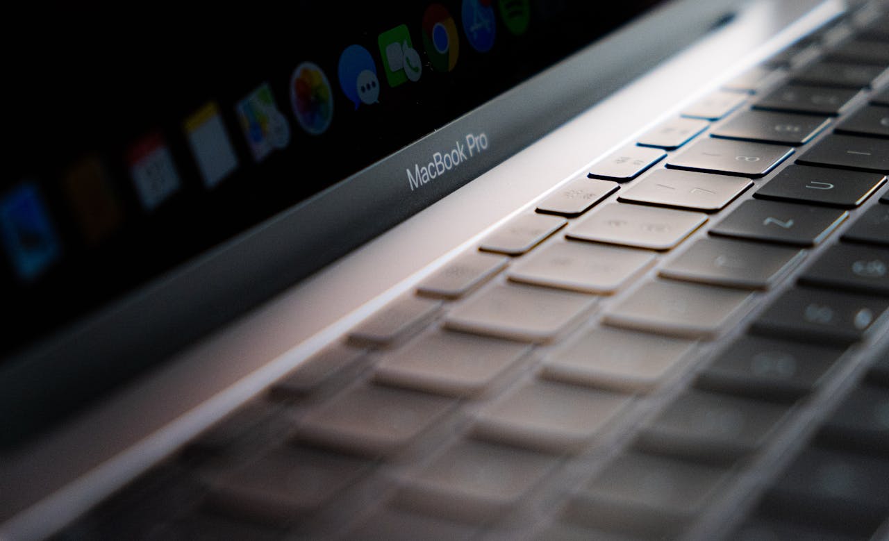 services-04 Detailed close-up of a MacBook Pro keyboard showing the keys and backlight.